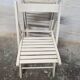 Pair of white wooden folding chairs
