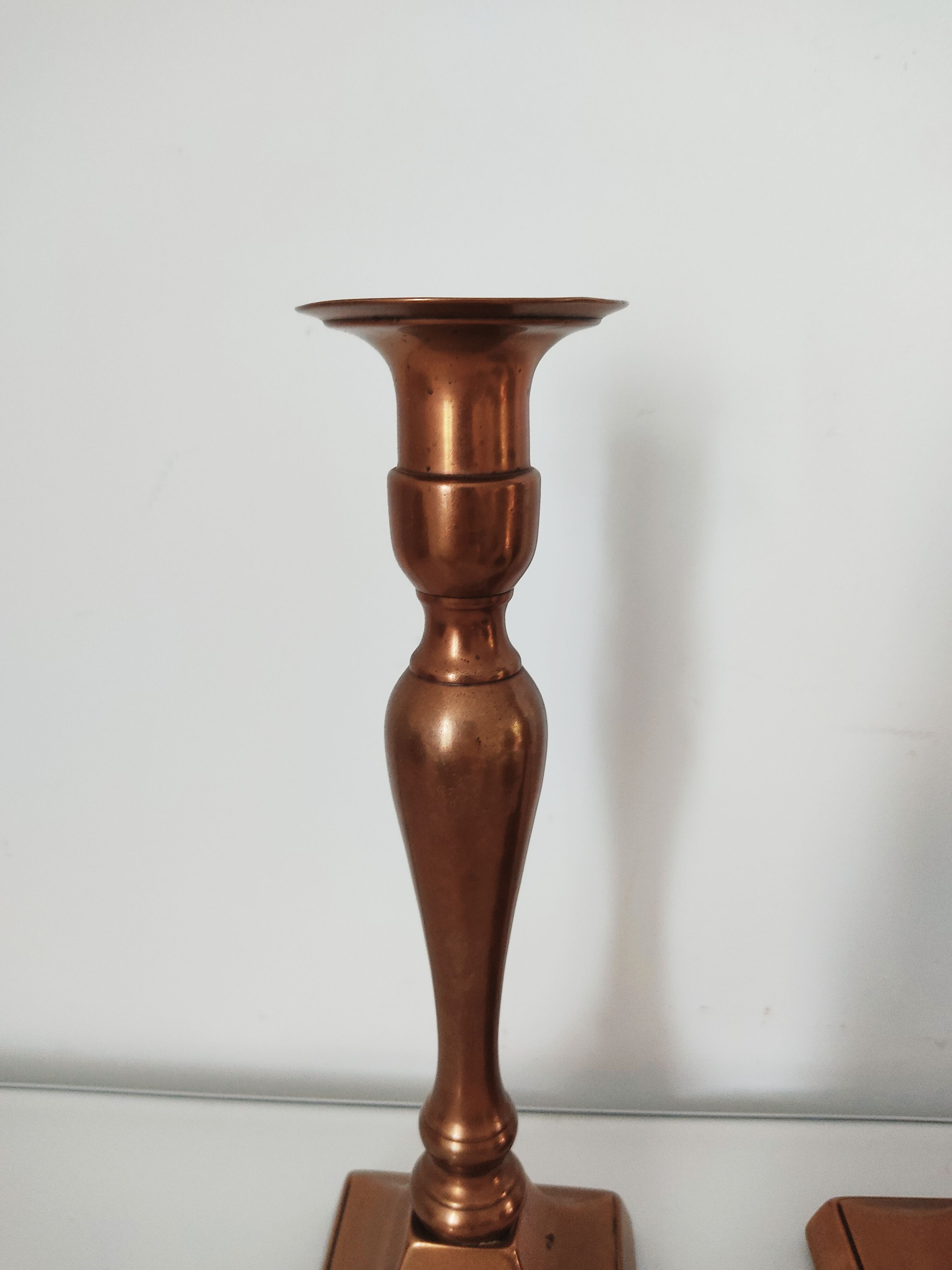 Set of a pair of candle holders and a hand candle holder