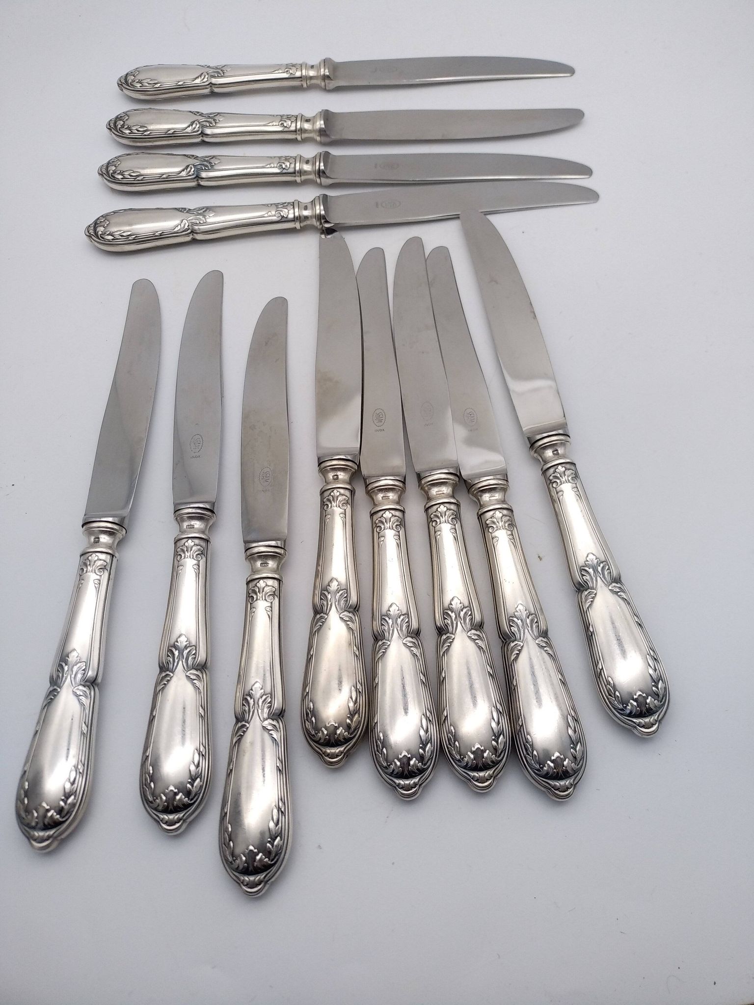 Set of 12 sfam knives in silver metal and stainless steel blades.