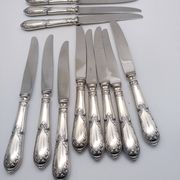 Set of 12 sfam knives in silver metal and stainless steel blades.