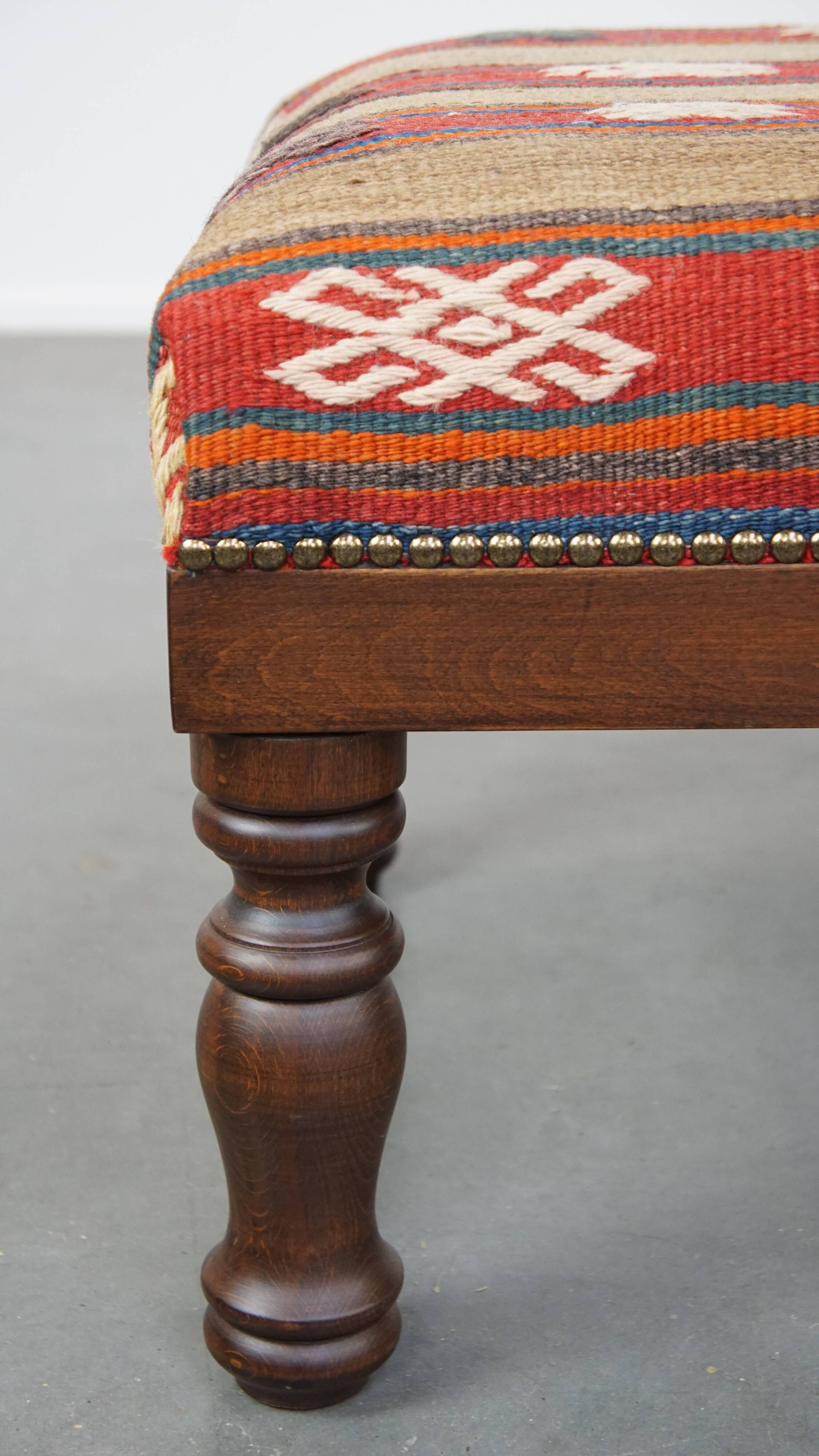 Oriental pouf upholstered in an antique kilim