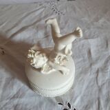 Small round box topped with a vintage biscuit porcelain angel