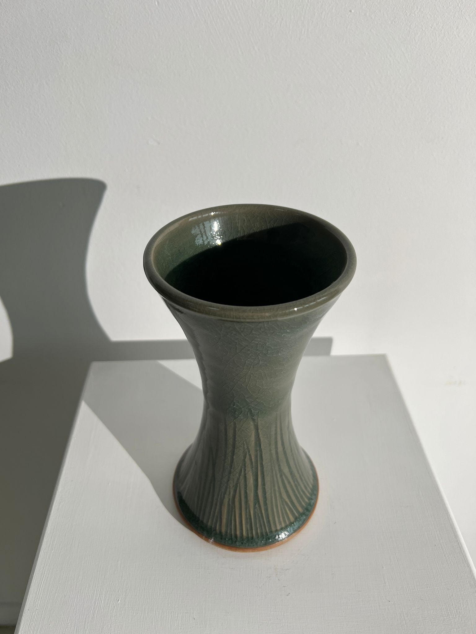 Dark green handcrafted vase with glazed ceramic grass blades