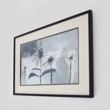 Framed painting with gray flower decor.