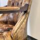 Antique Chesterfield Wing Chair with Stool and English Side Table