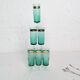 Set of 6 green champagne flutes with a golden rim.