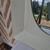 Oval mirror with a distressed white frame