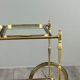Rolling table cart in gilded brass with two glass shelves, 20th century.