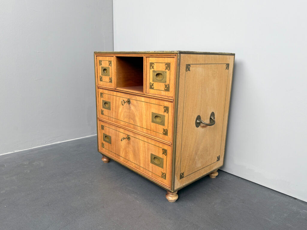 Antique campaign chest / ship’s chest, England, 1940s. Mahogany with a distinctive grain, brass inlays and hardware.