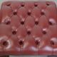 In very good condition elegant red/brown chesterfield ottoman made of cow leather