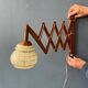 Vintage wall lamp with teak wood scissors and glass shade.