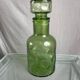 Green glass bottle with craters