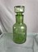 Green glass bottle with craters