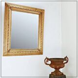 Large gilded wood and stucco mirror with foliage