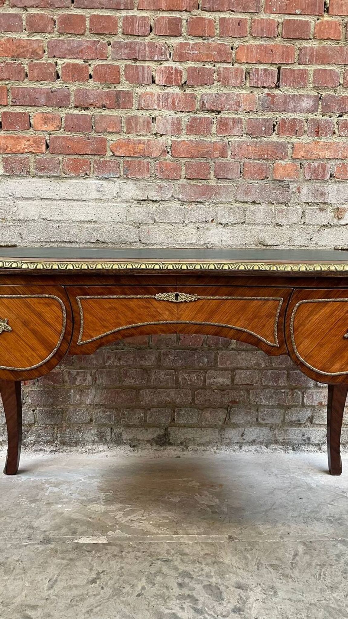 Antique French-style desk with green leather top and bronze mounts