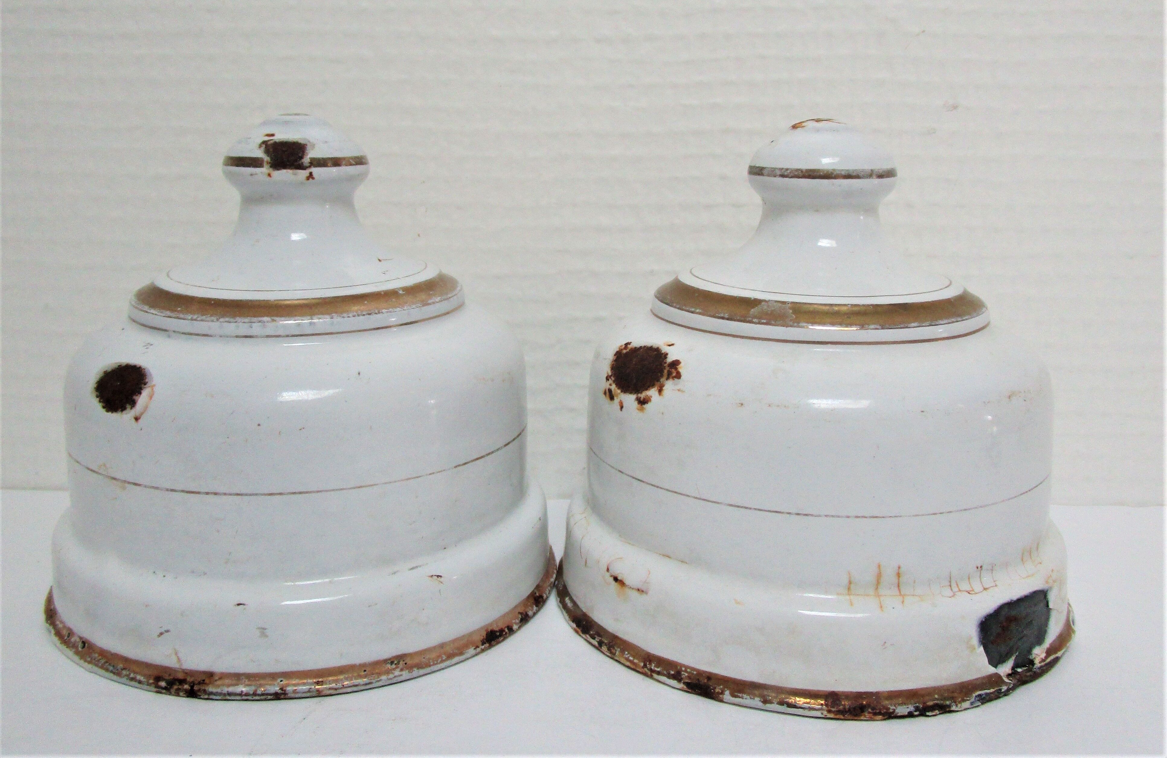 Four white enamelled metal cheese bells early twentieth century