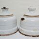 Four white enamelled metal cheese bells early twentieth century
