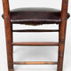 Antique rustic armchair in walnut and leather, 18th century.