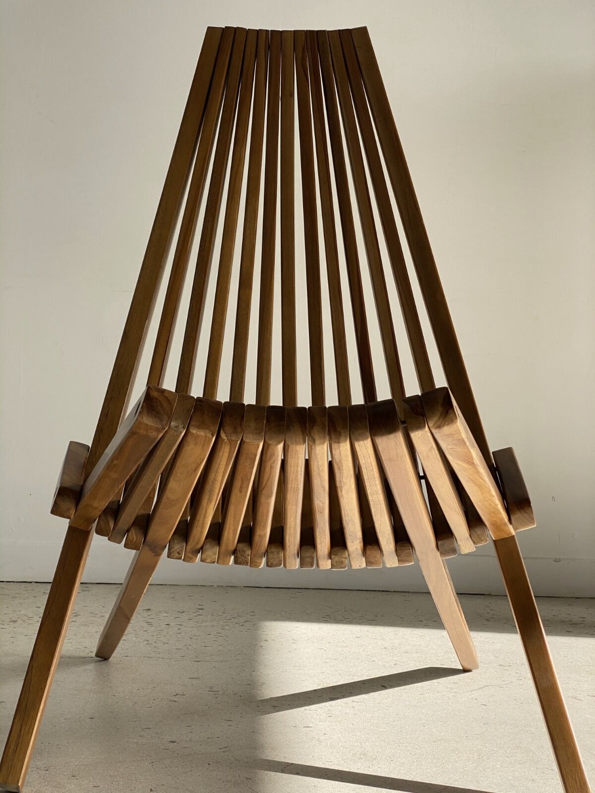 Foldable designer armchair in wooden slats