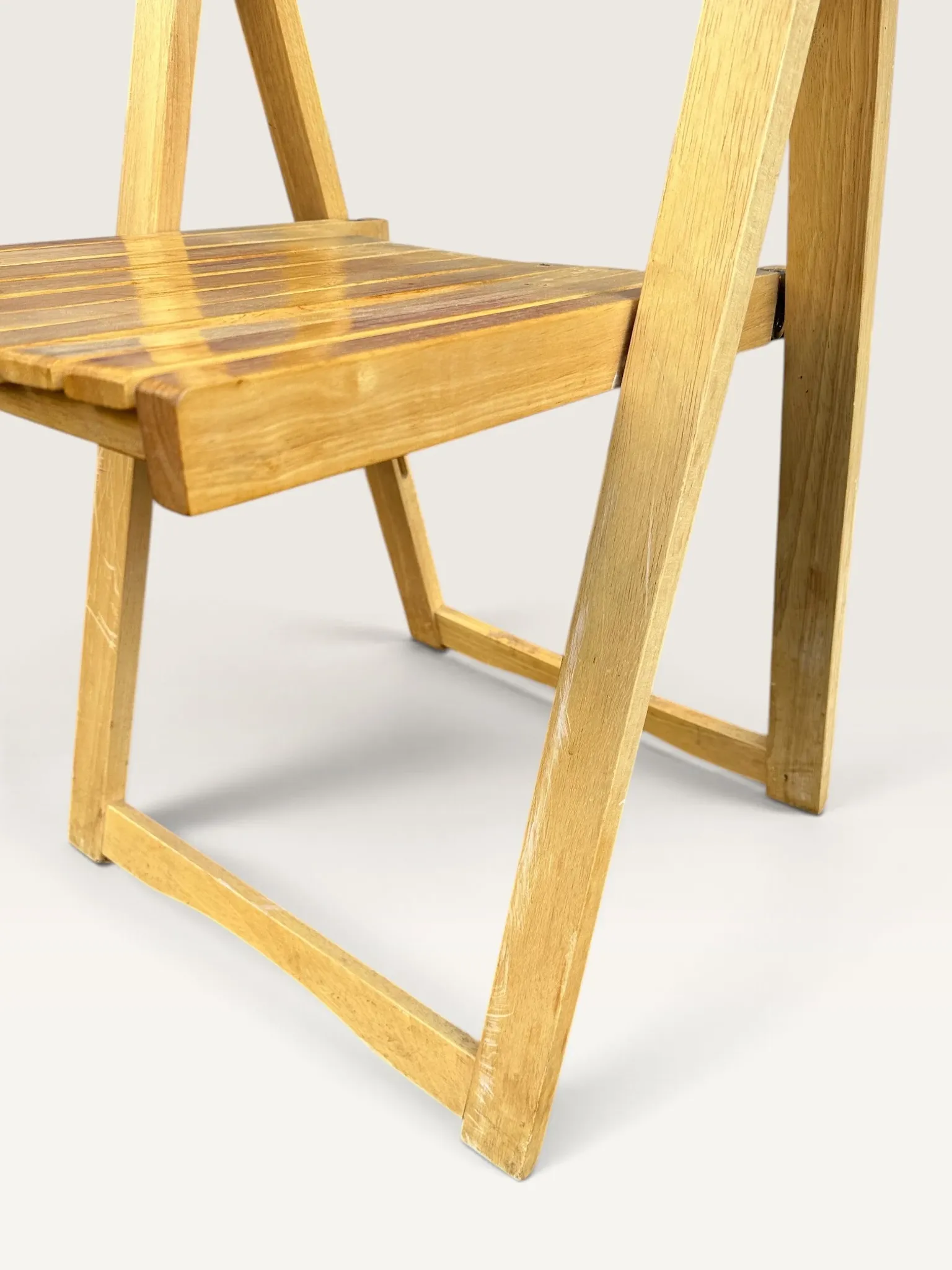 Blonde wooden folding chair in the style of Aldo Jacober.