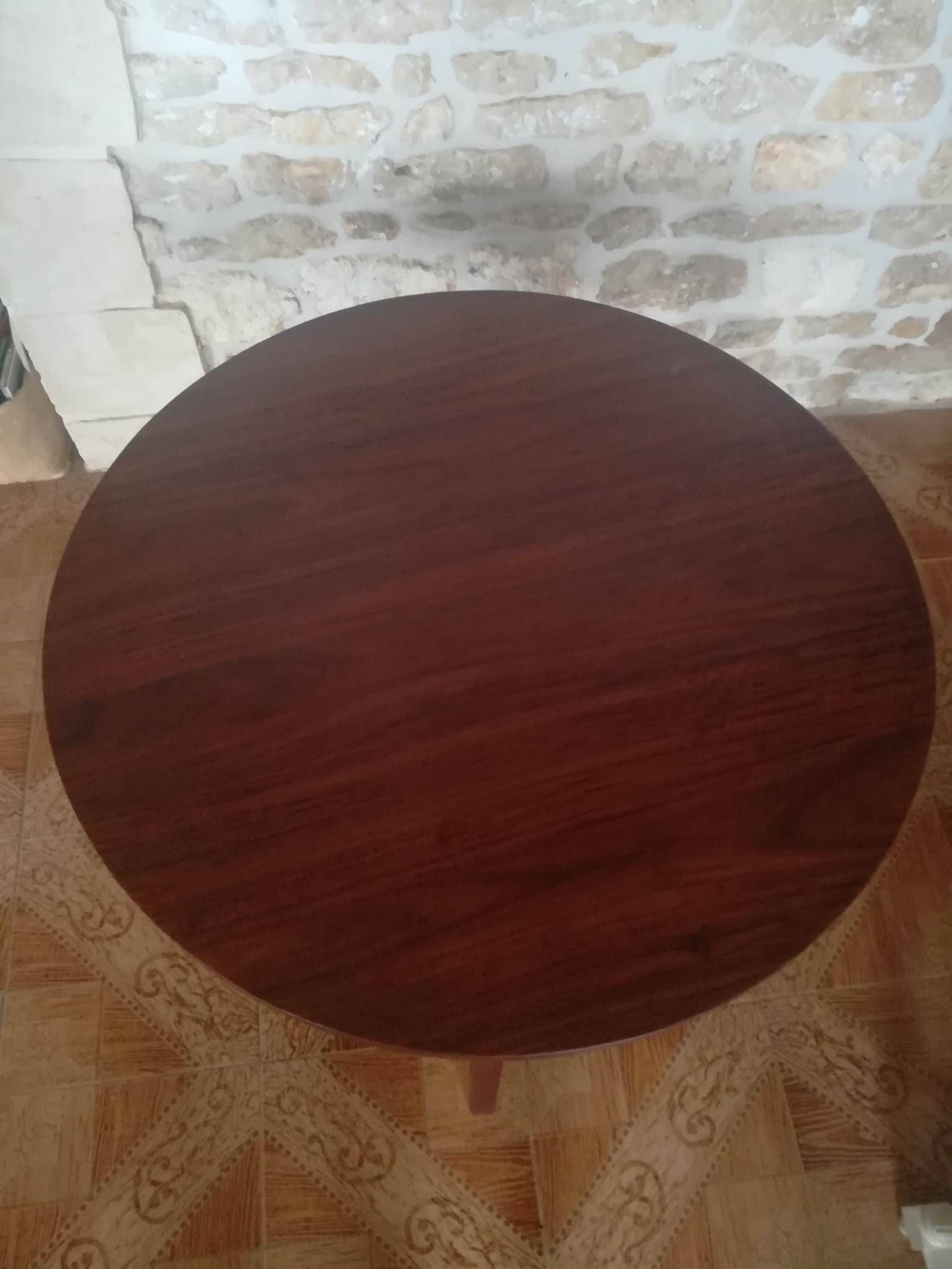 Round wooden table with thin legs