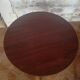 Round wooden table with thin legs