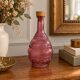 Vintage pink pressed glass carafe – retro decorative bottle with wooden stopper.