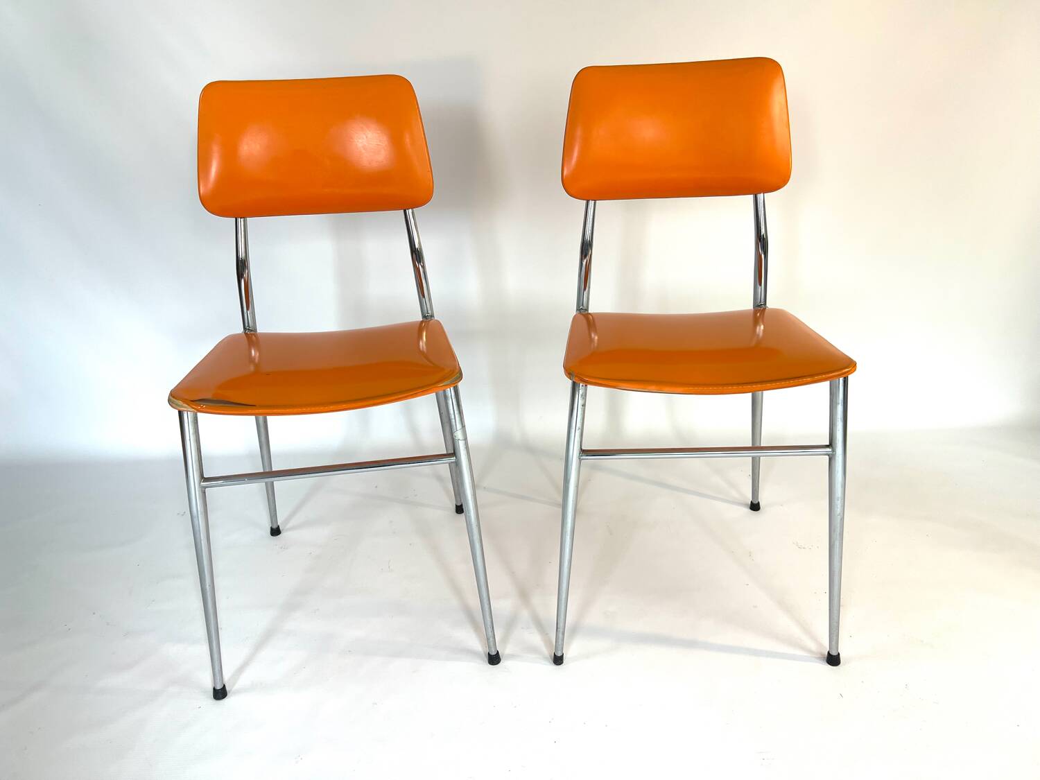Pair of vintage orange leatherette chairs