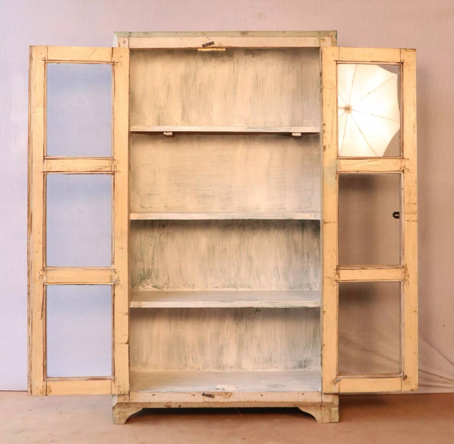 Teak display cabinet with a white-green patina.
