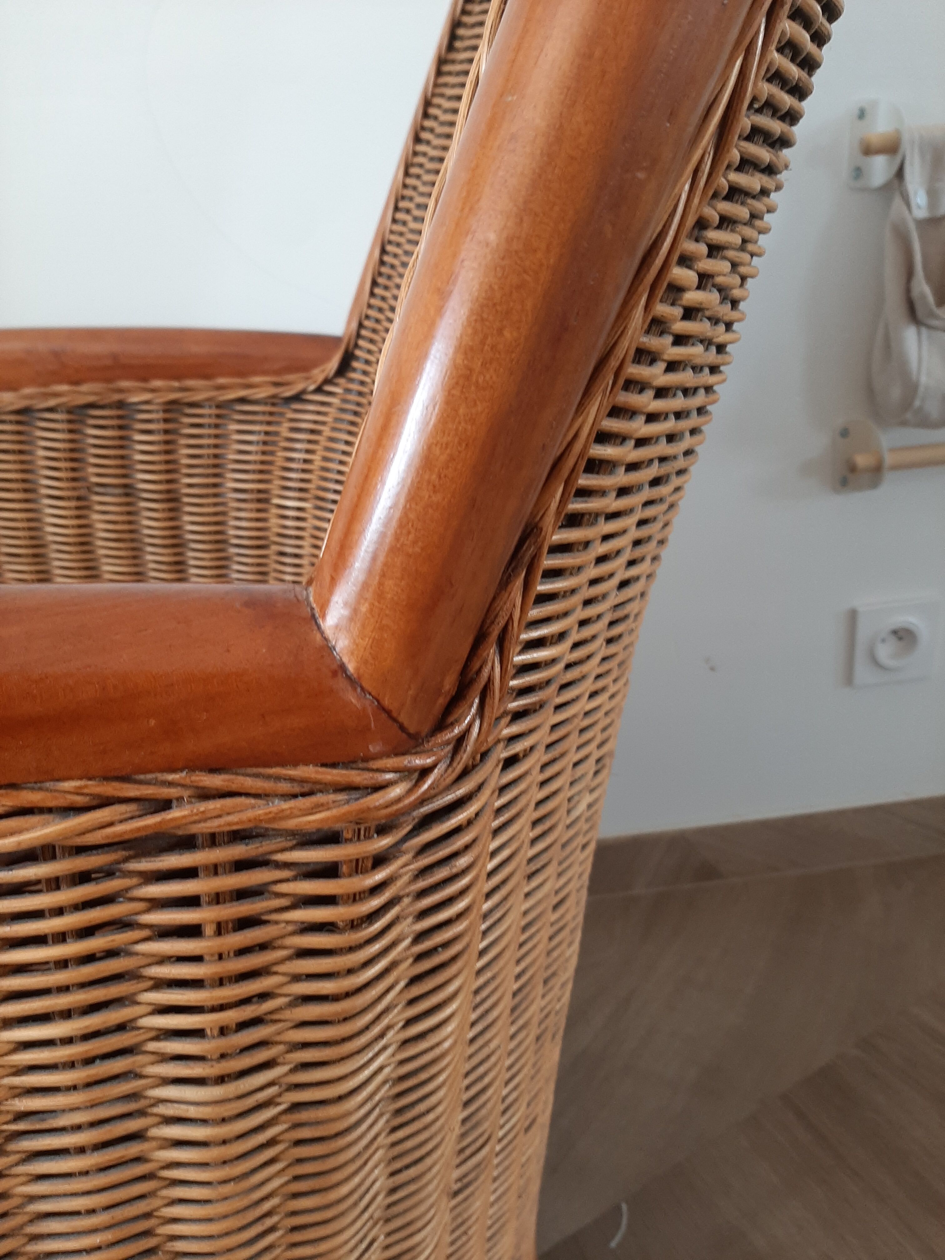 Armchair in woven rattan and exotic wood