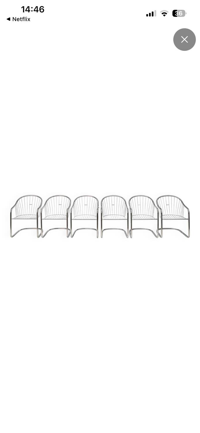 6 chrome metal chairs in the style of Gastonne Ronaldo.