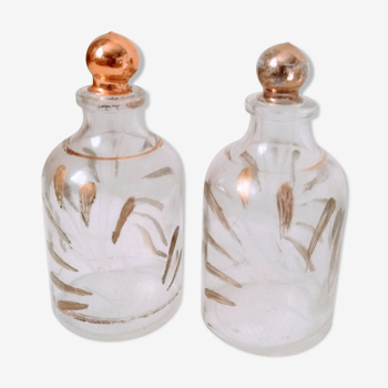 2 bottles / small old style glass bottles the patterns of golden leaves have been repainted