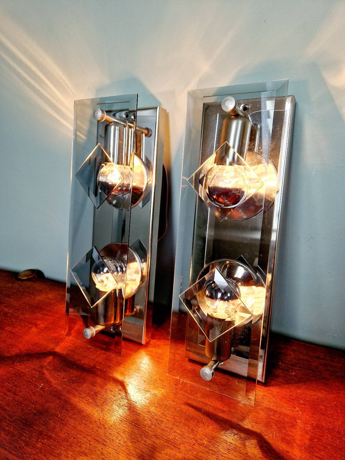 Pair of chrome metal and smoked glass wall sconces, 1970s.