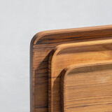 Trio of rounded rectangular trays or cups in monoxyl teak L:35