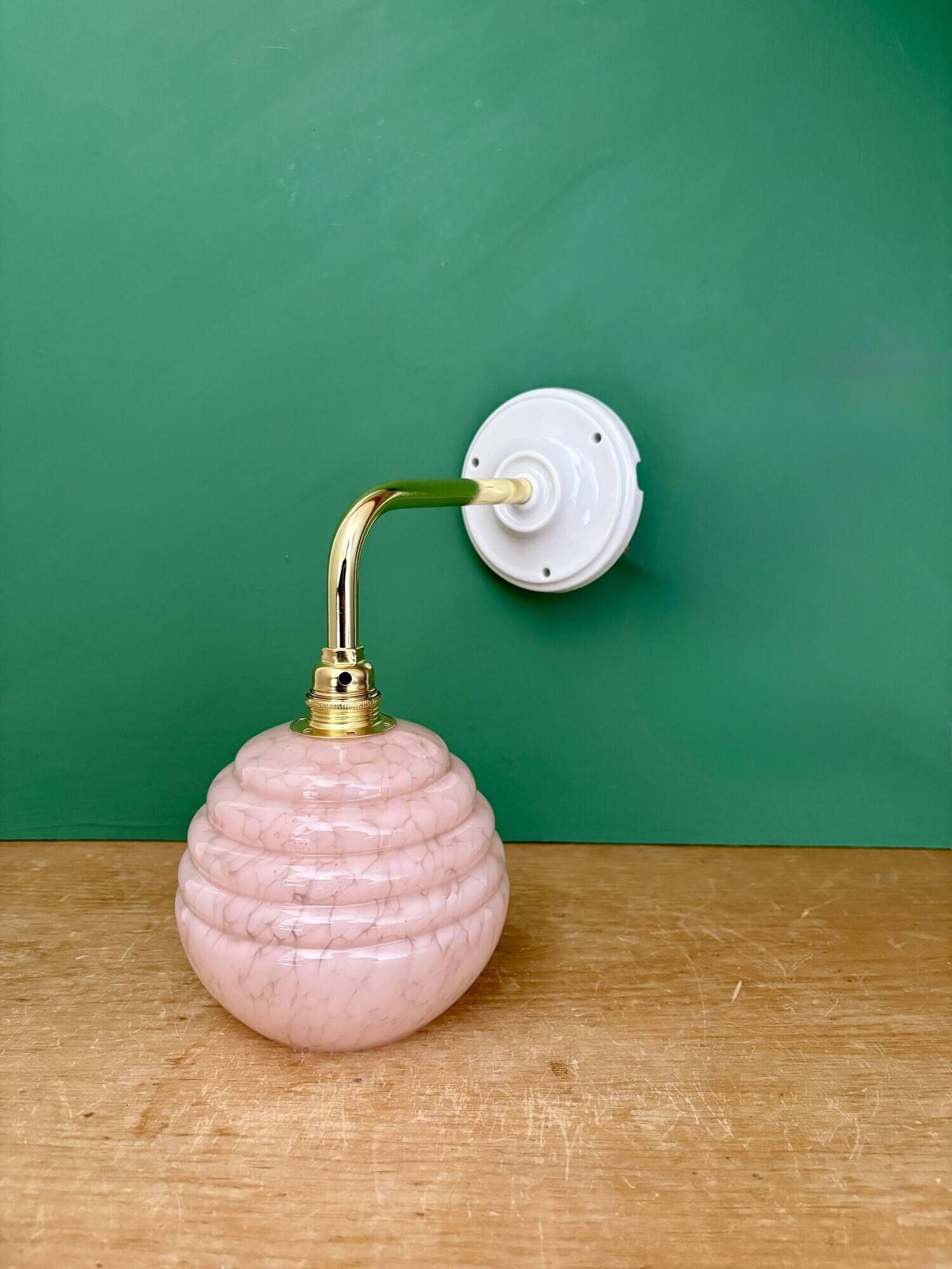 Vintage pink Clichy glass globe wall light.