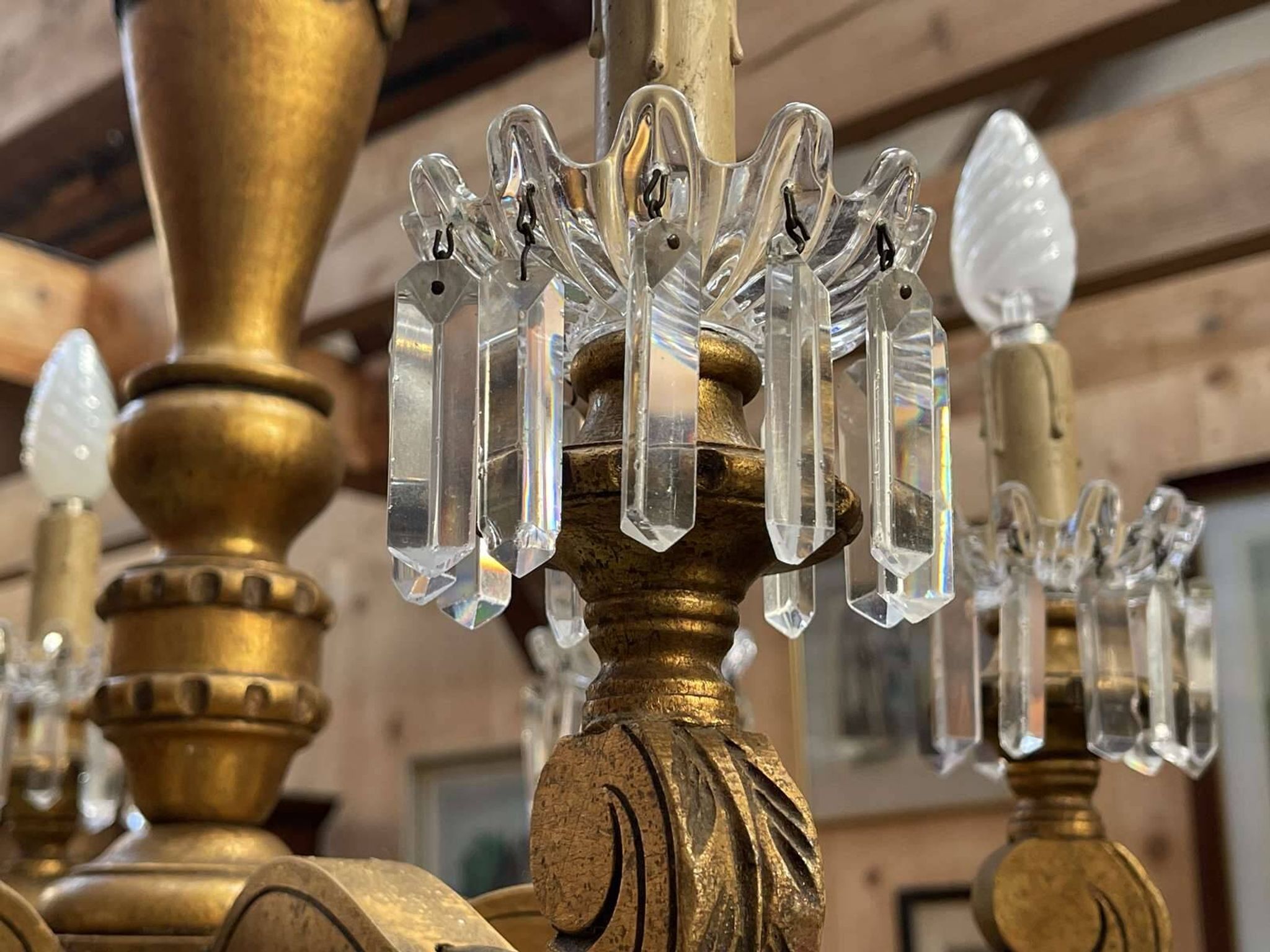 Golden wooden chandelier with crystal pendants from the 19th century.