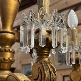 Golden wooden chandelier with crystal pendants from the 19th century.