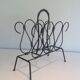 Magazine rack in leather and black lacquered metal. Attributed to Jacques Adnet