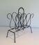 Magazine rack in leather and black lacquered metal. Attributed to Jacques Adnet