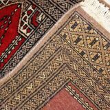 Tapis vintage fait main Bukhara de prière en laine rouge (45cm x 101cm)