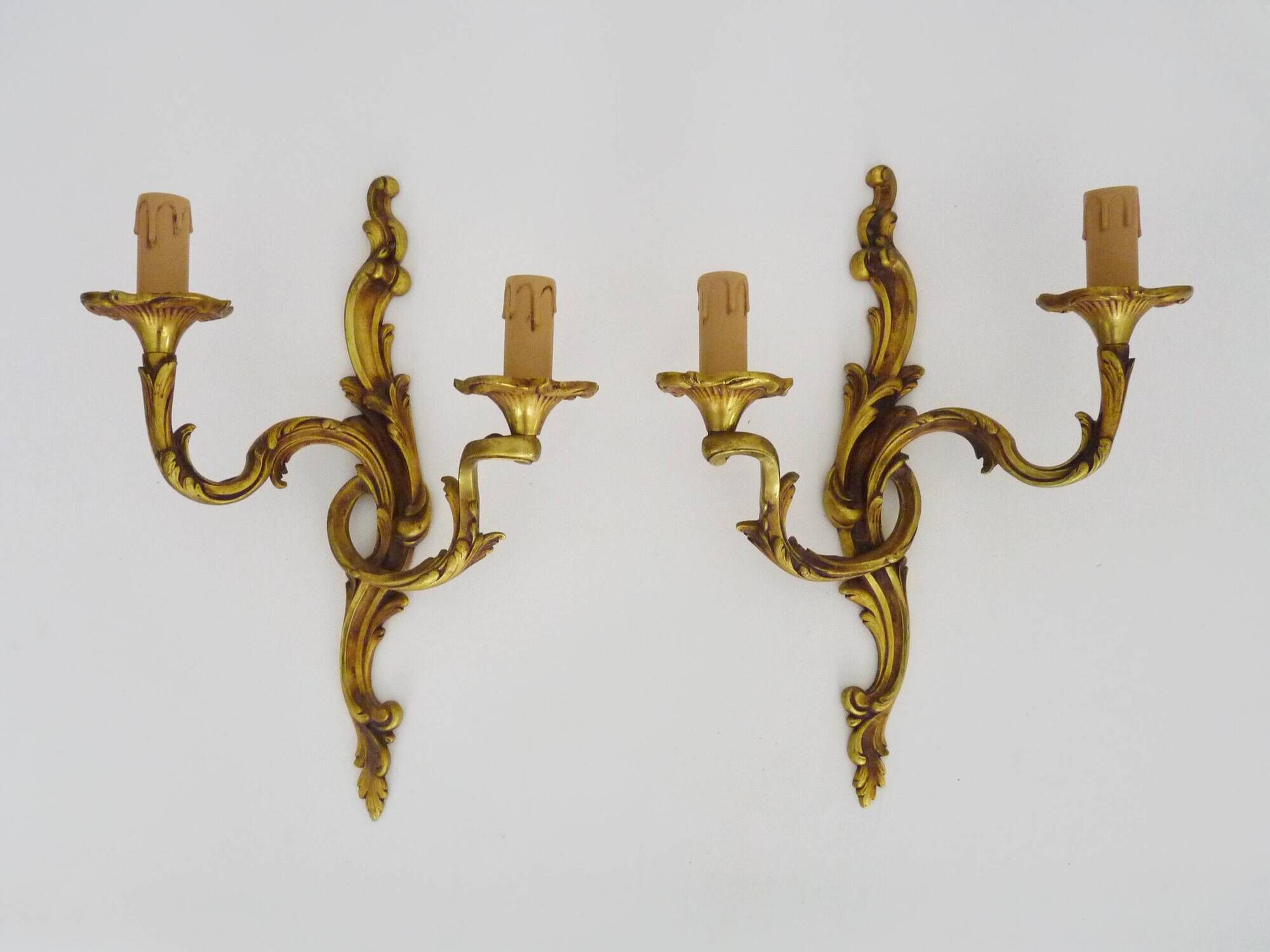 Antique pair of double-light bronze wall sconces with acanthus leaves. 1950s
