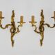 Antique pair of double-light bronze wall sconces with acanthus leaves. 1950s