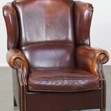 Dark English style sheepskin wingback chair with character and patina