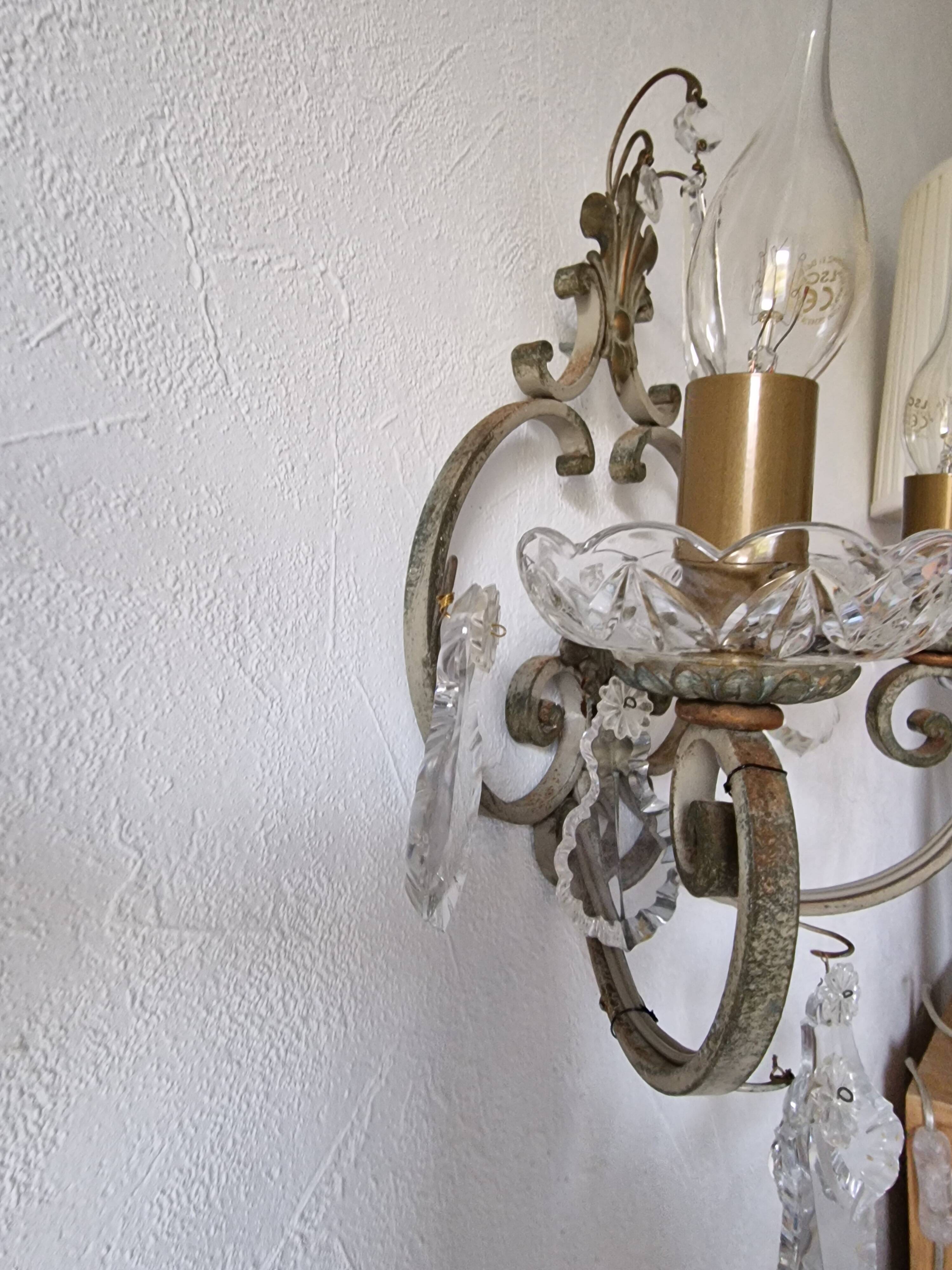 Pair of sconces in patinated metal and crystal tassels