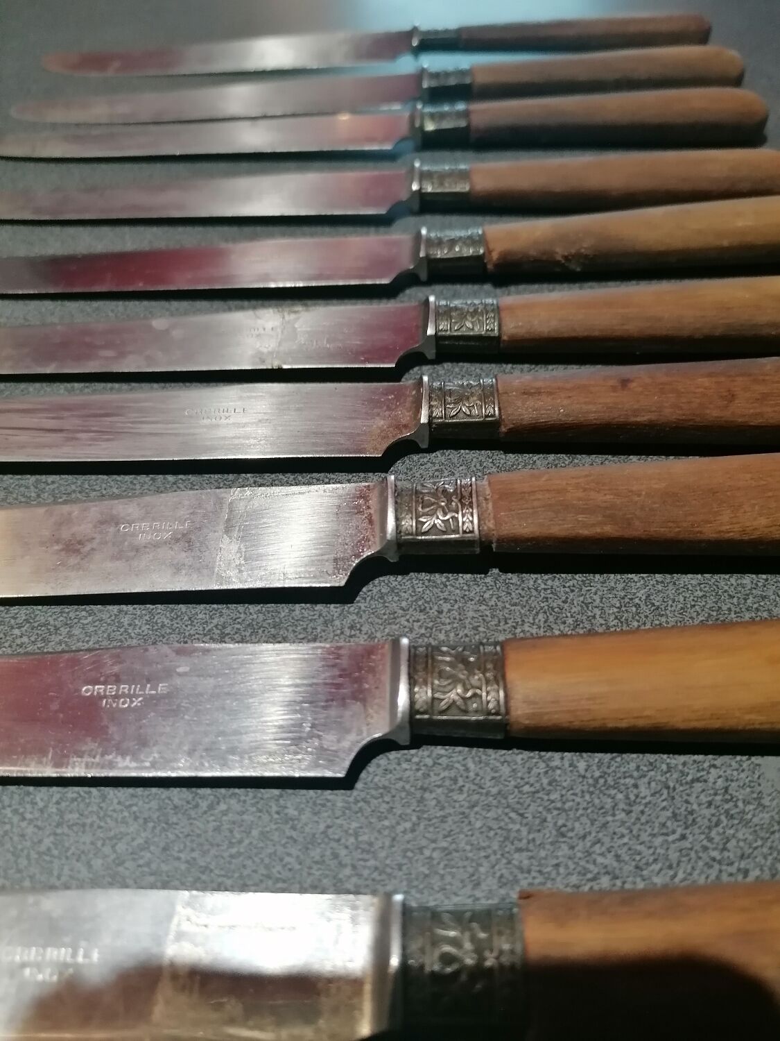 Old table knives and dessert knives, wooden handles, stainless steel blades