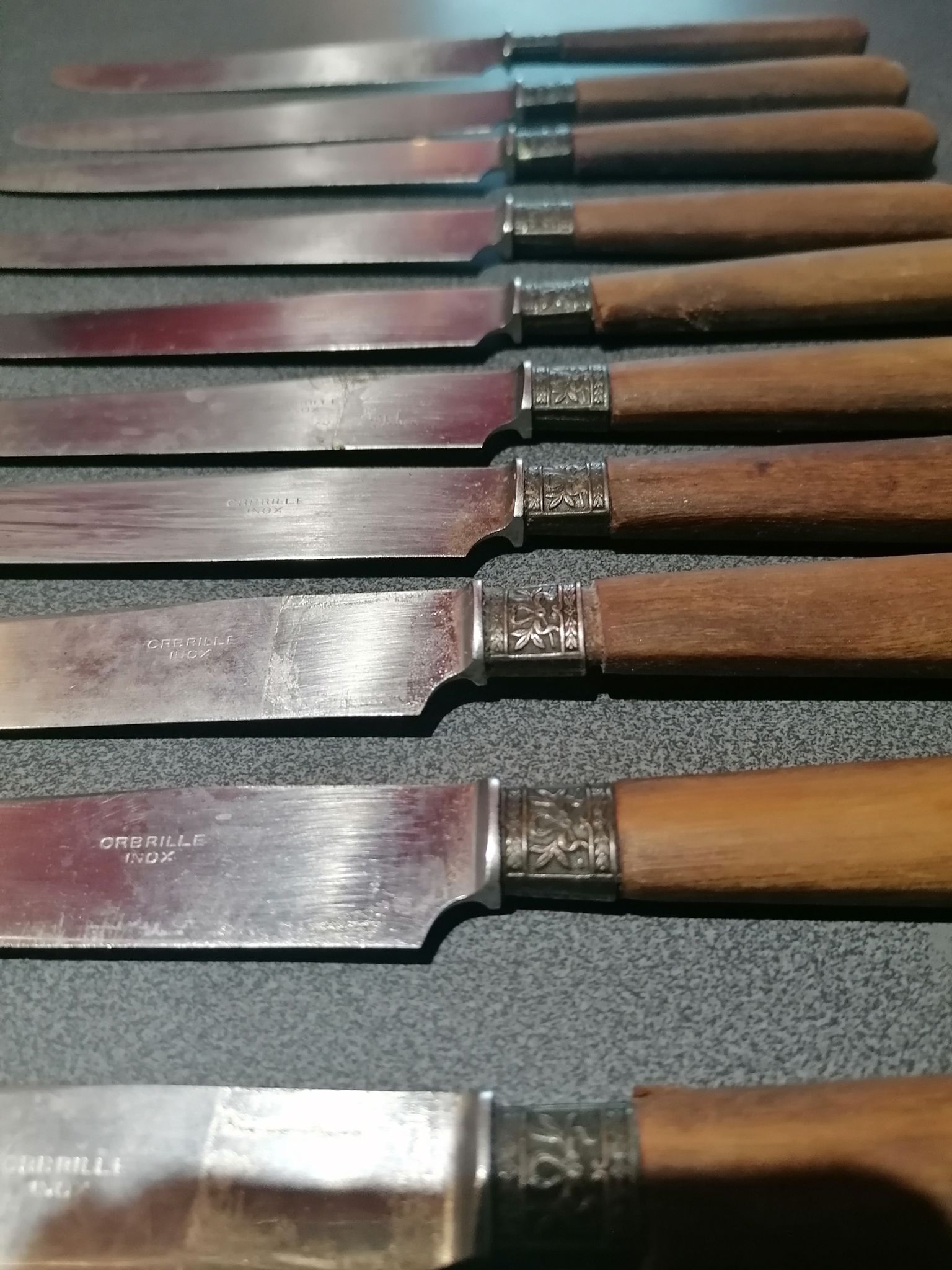 Old table knives and dessert knives, wooden handles, stainless steel blades