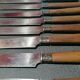 Old table knives and dessert knives, wooden handles, stainless steel blades