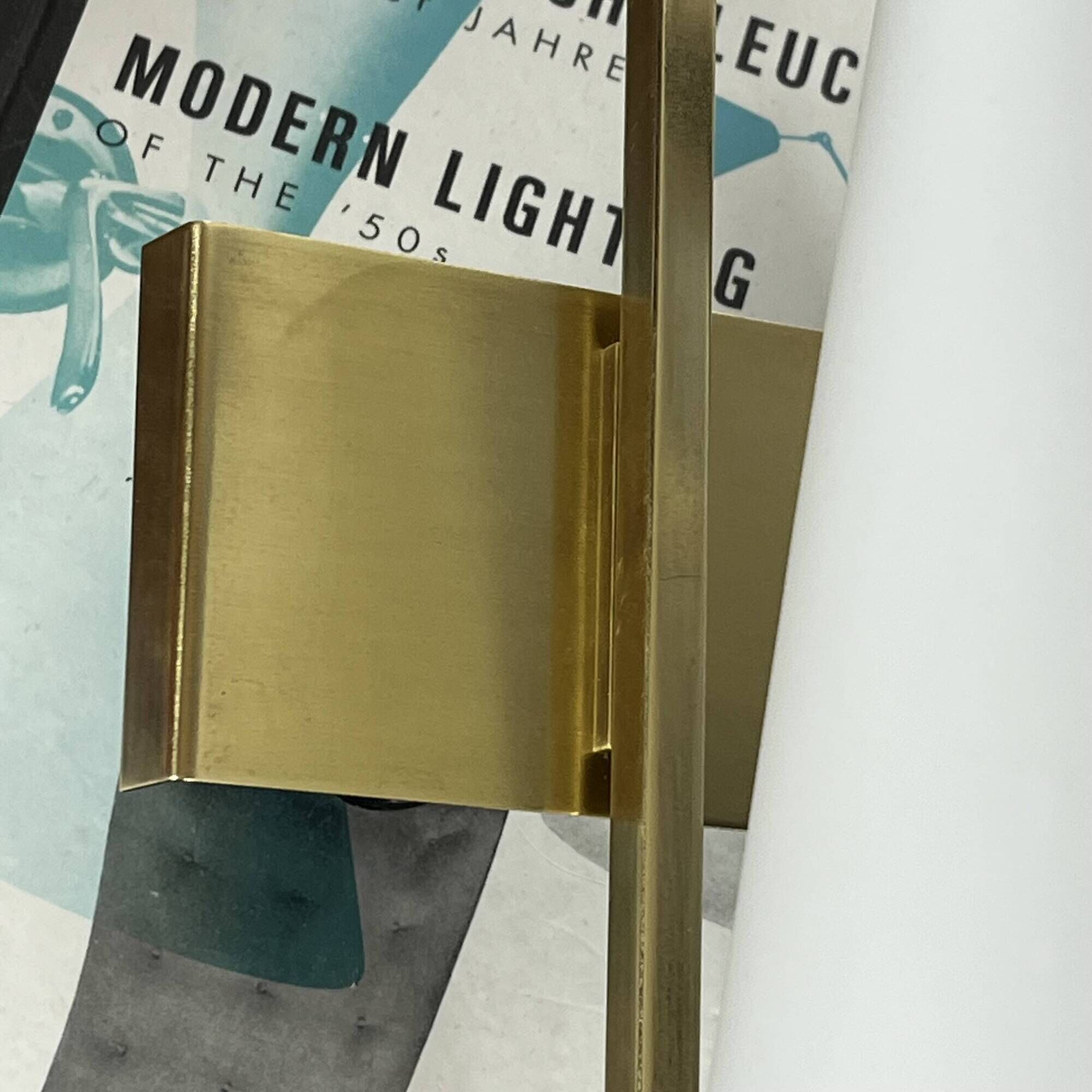 Vintage brass wall light with a white glass spindle shade from the 1950s-1960s.
