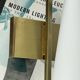 Vintage brass wall light with a white glass spindle shade from the 1950s-1960s.