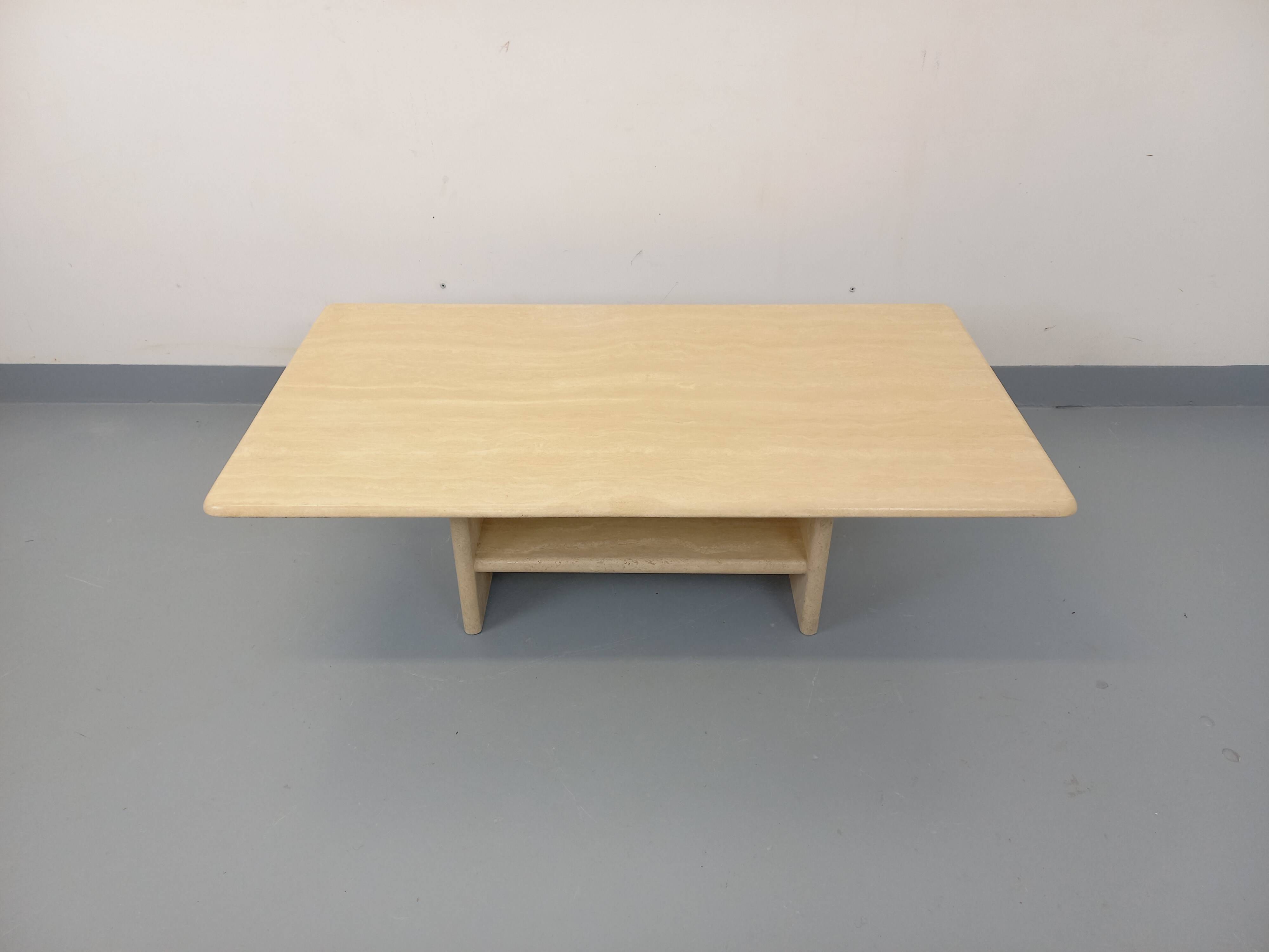 Vintage rectangular coffee table in travertine with magazine rack.